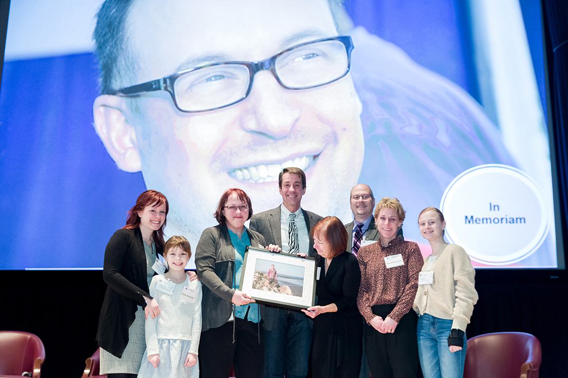 Austin stands with Geoff’s family on stage