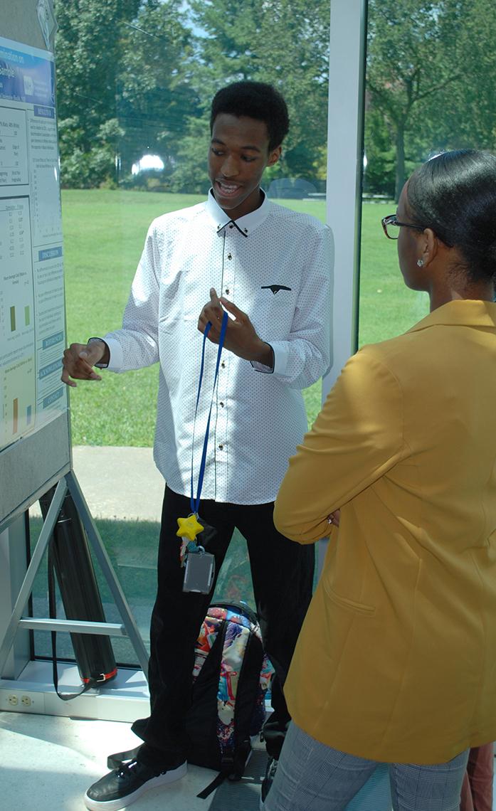 Students look at science poster