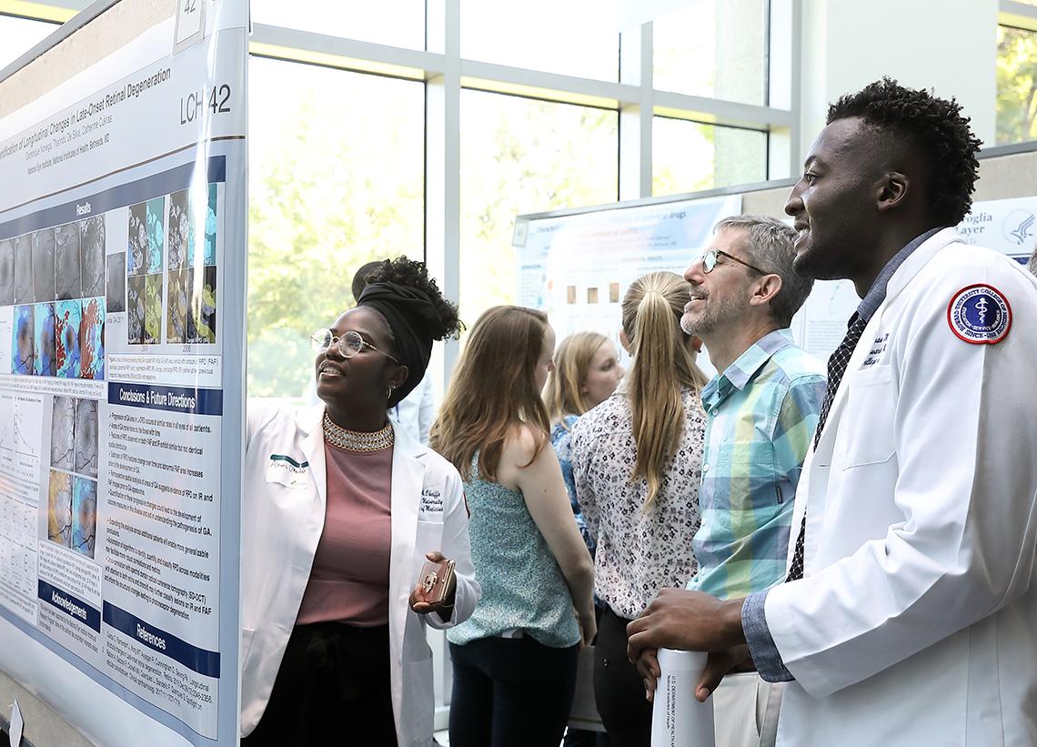A student shows off her work to a group of youngsters.