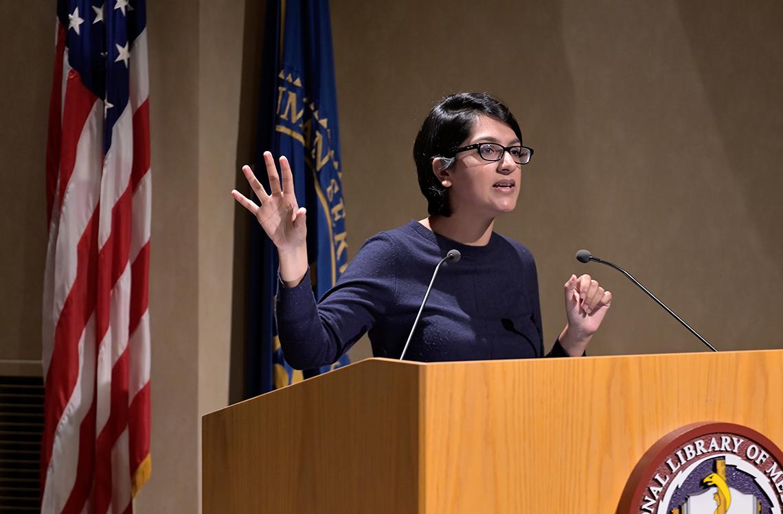 Saini speaks at podium