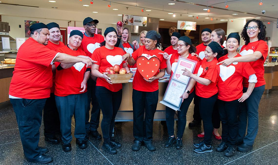 The Bldg. 31 cafeteria staff is all smiles, wearing red shirts with heart.
