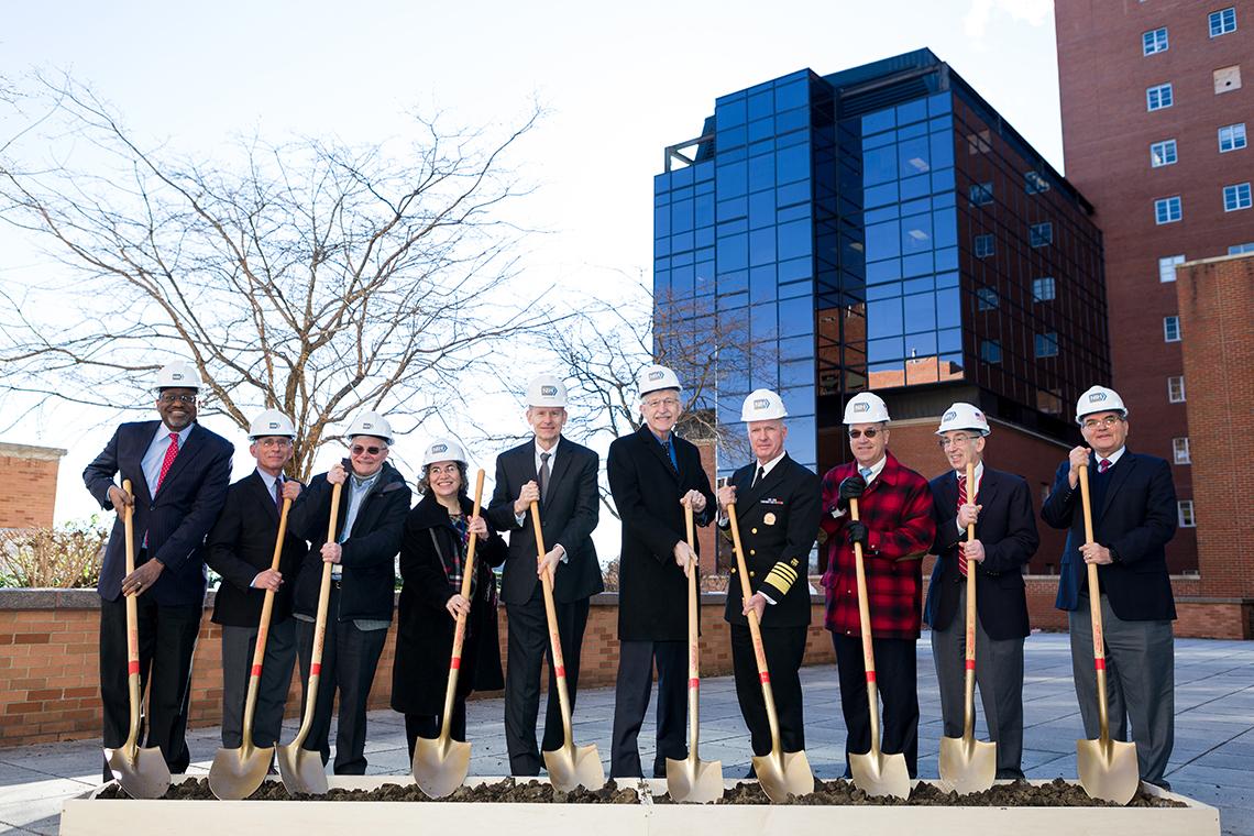 NIH leadership use shovels to break ground