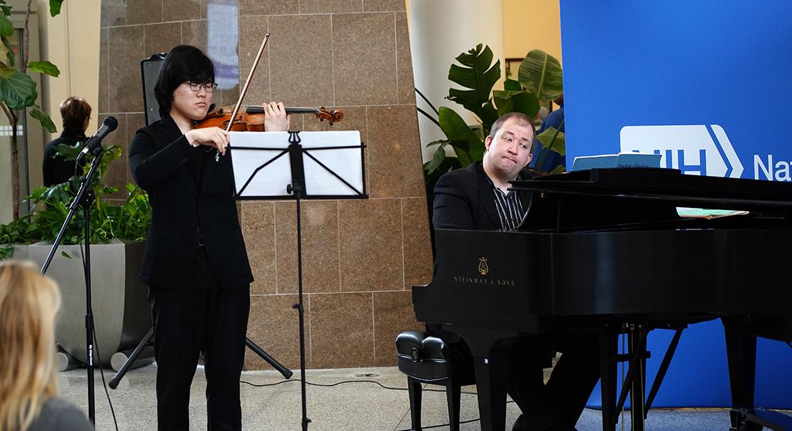  Naito and  Morozov play music in the hospital atrium