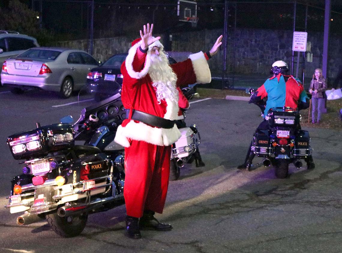 Santa Claus gets off his Harley-Davidson motorcycle upon his arrival at Children's Inn.
