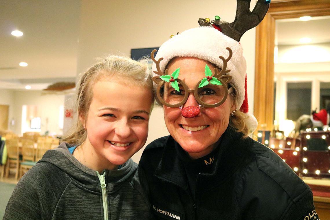 Police officer in costume poses with young female patient.