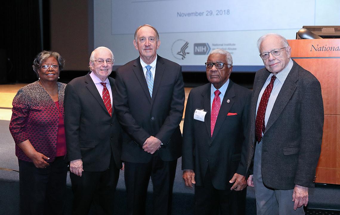 May with NIAAA and NIDDK alumni pose near stage after event
