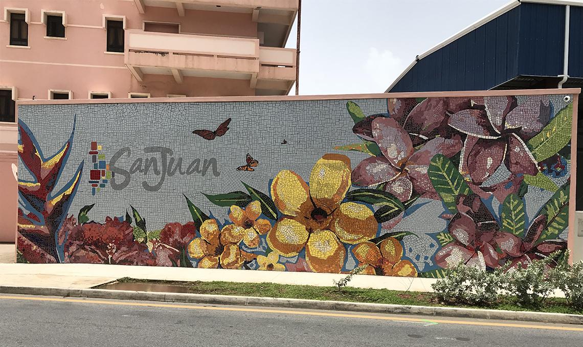 A mural of yellow and pink flowers graces a city wall in San Juan, Puerto Rico