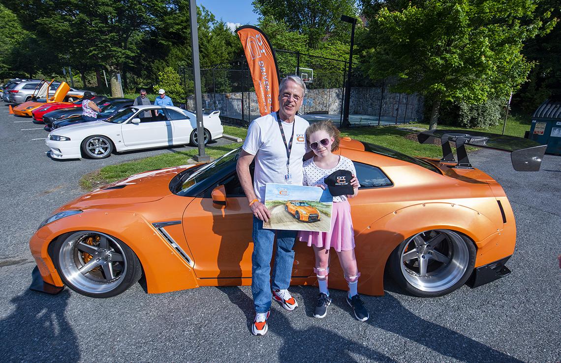 Lee and Jenna in front of Nissan GTR sportscar