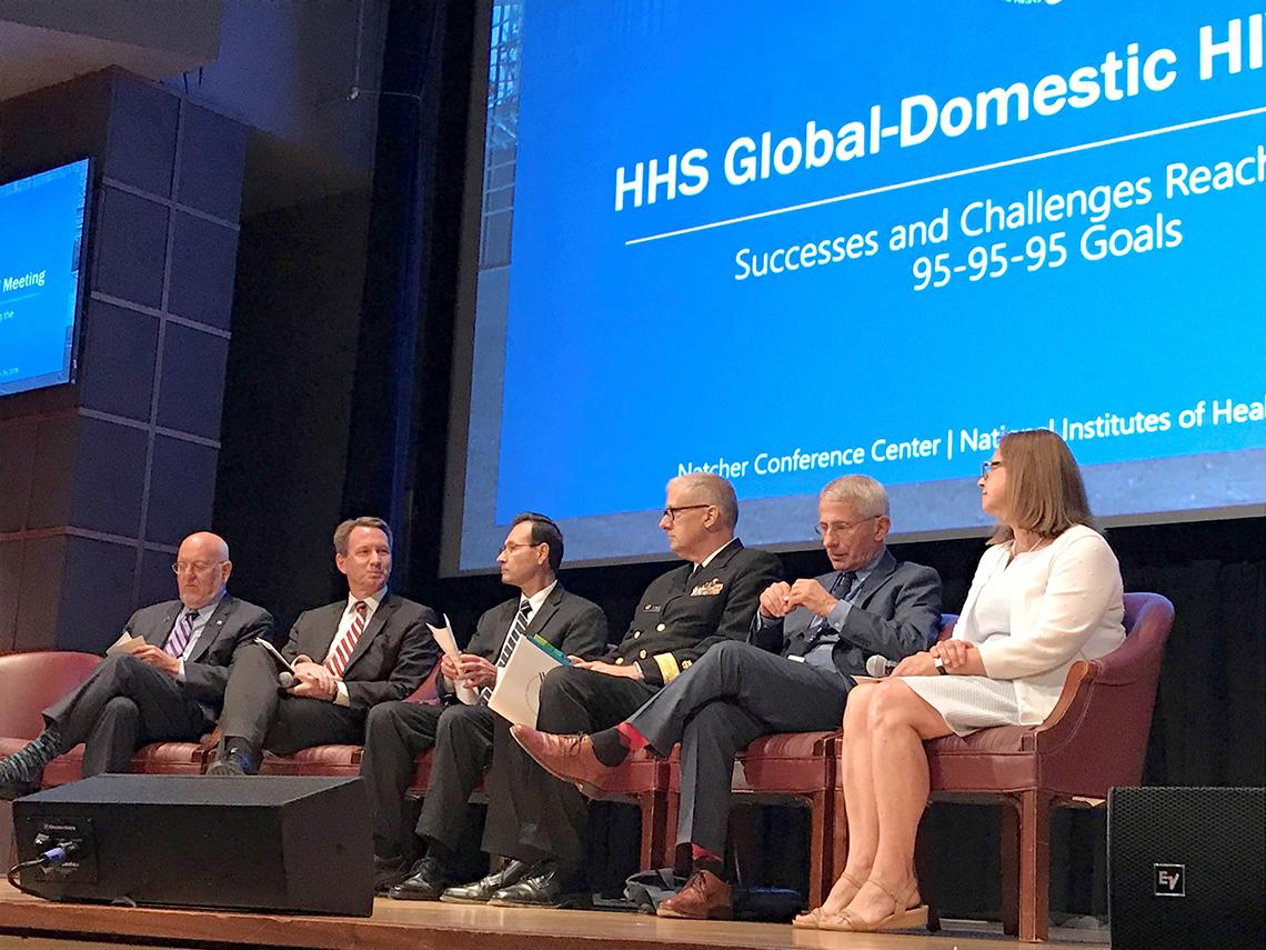 Six panelists sit at HIV meeting