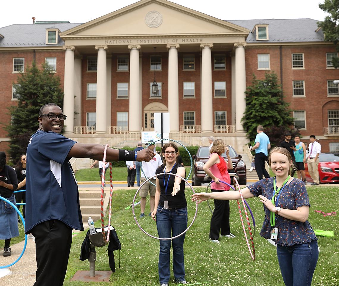 Participants hula hoop on the lawn