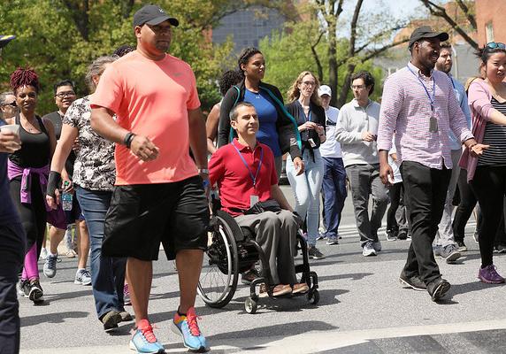 Participant using wheelchair amid walkers starting 5K