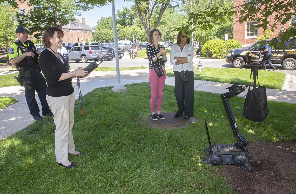 Clinical Center nurse guides robot remotely.