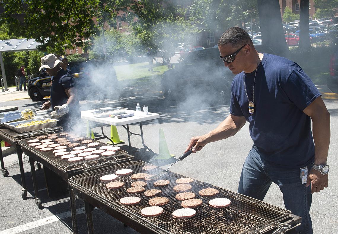 Two officers grill food for lunch