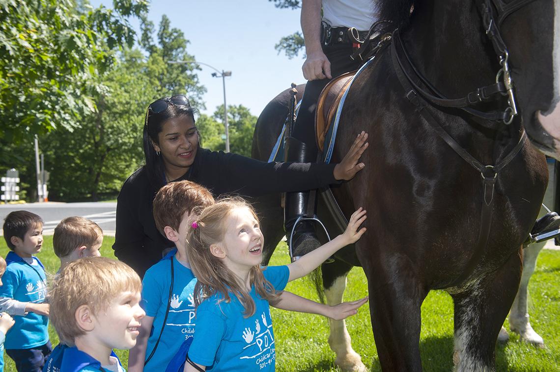 Kids visit with officers on horseback.