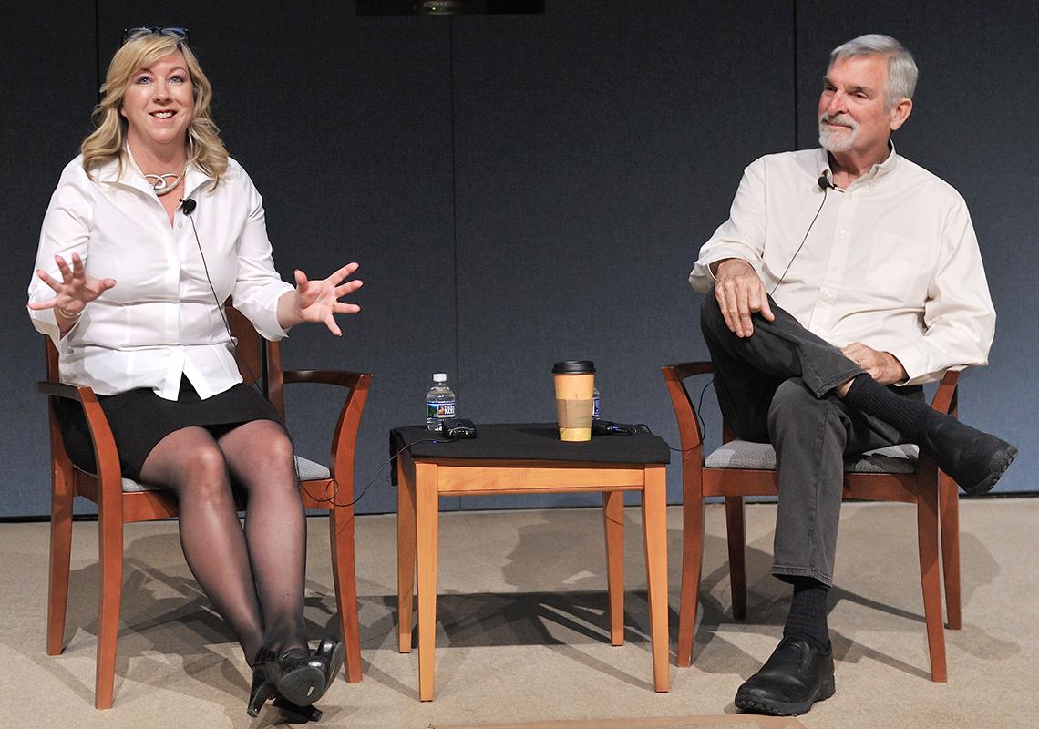 Strathdee, seated on stage with husband Patterson