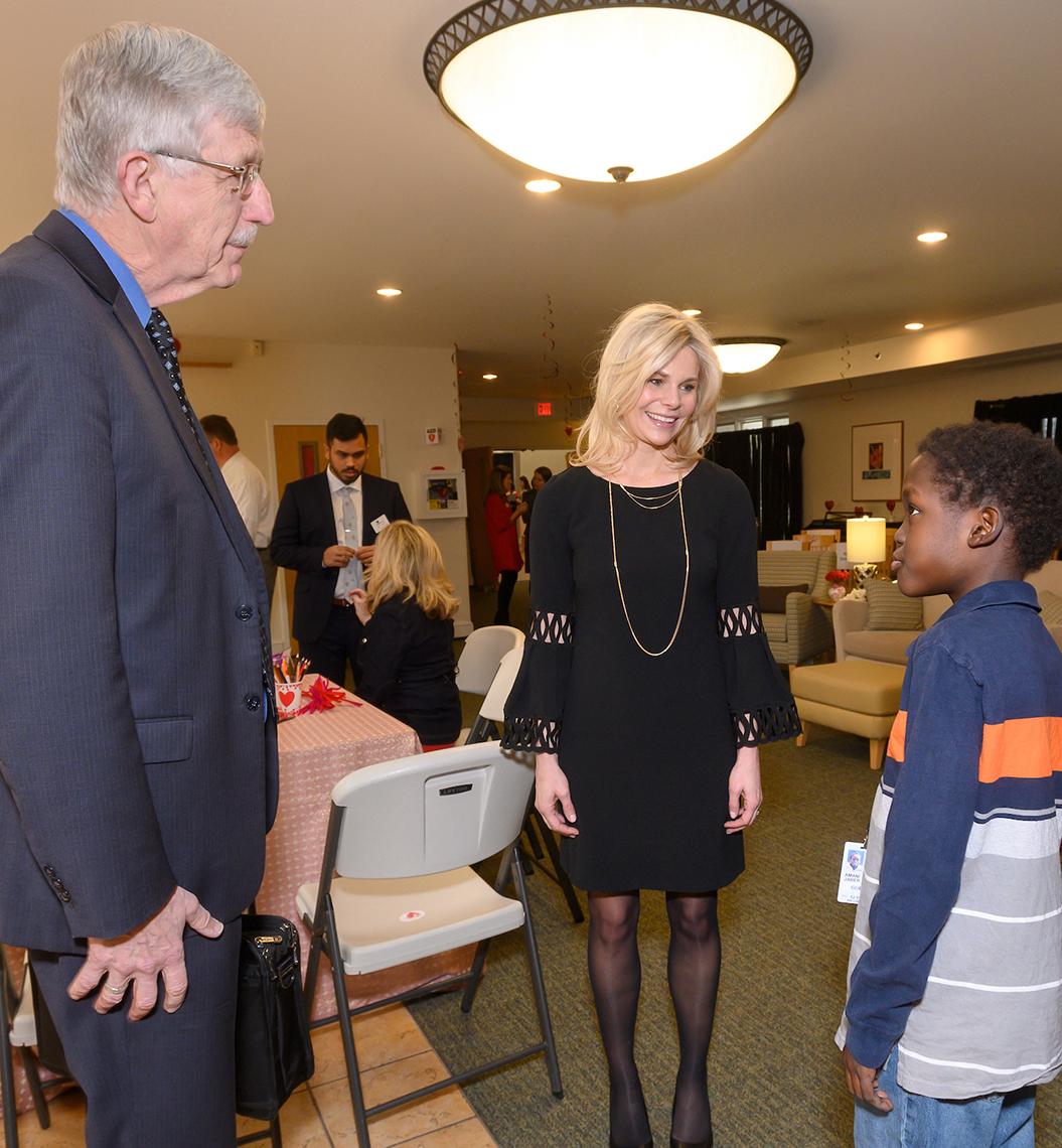 Collins and Lucca stand chatting with inn resident