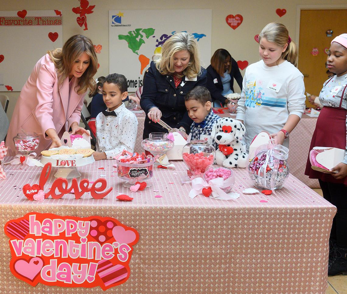 First Lady Trump and young inn resident chooses sugar cookies for a gift box 