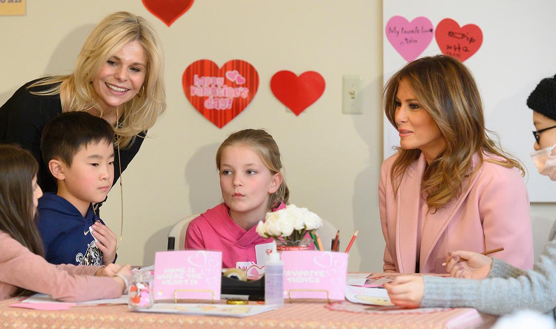Lucca (standing) and First Lady (seated) interact with kids