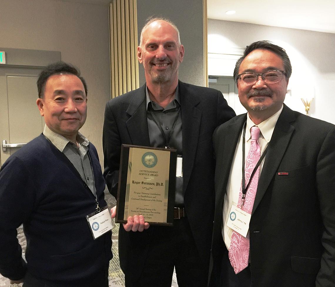 Dr. Sorensen shows his award with Dr. Lin and Dr. He