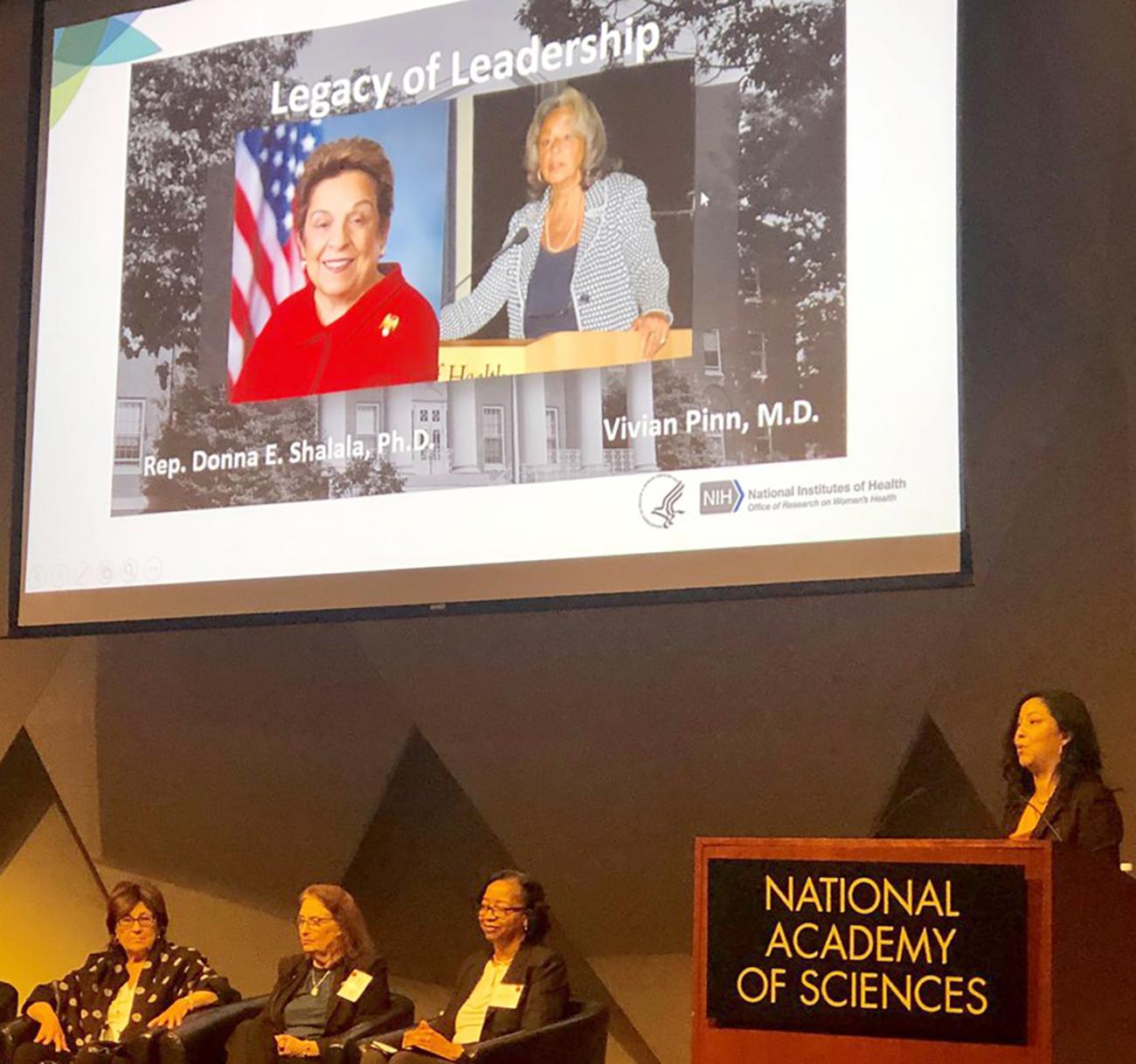 Dr. Clayton speaks at the podium.