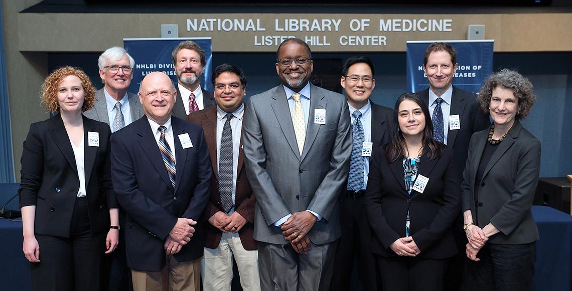 NHLBI director Dr. Gibbons poses with NHLBI staff in Lister Hill auditorium.