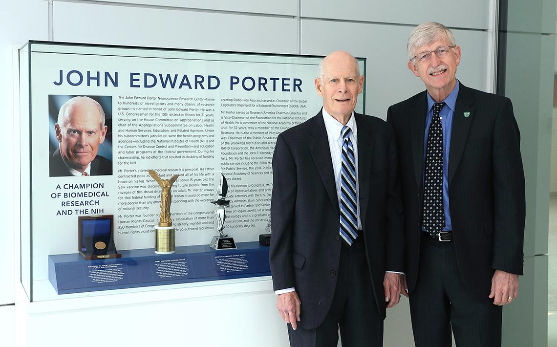 Porter stands with Collins in front of new exhibit.