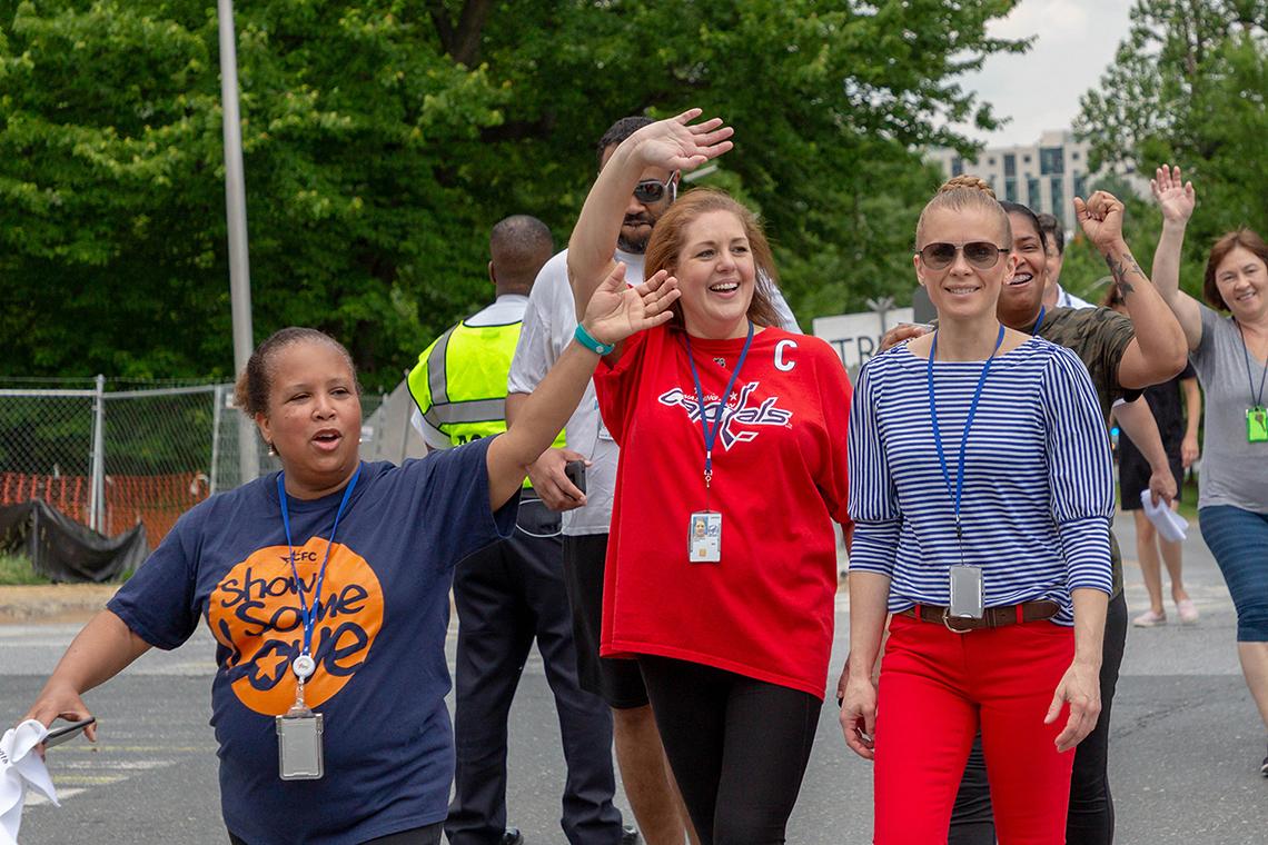 Group of walkers smiling, waving