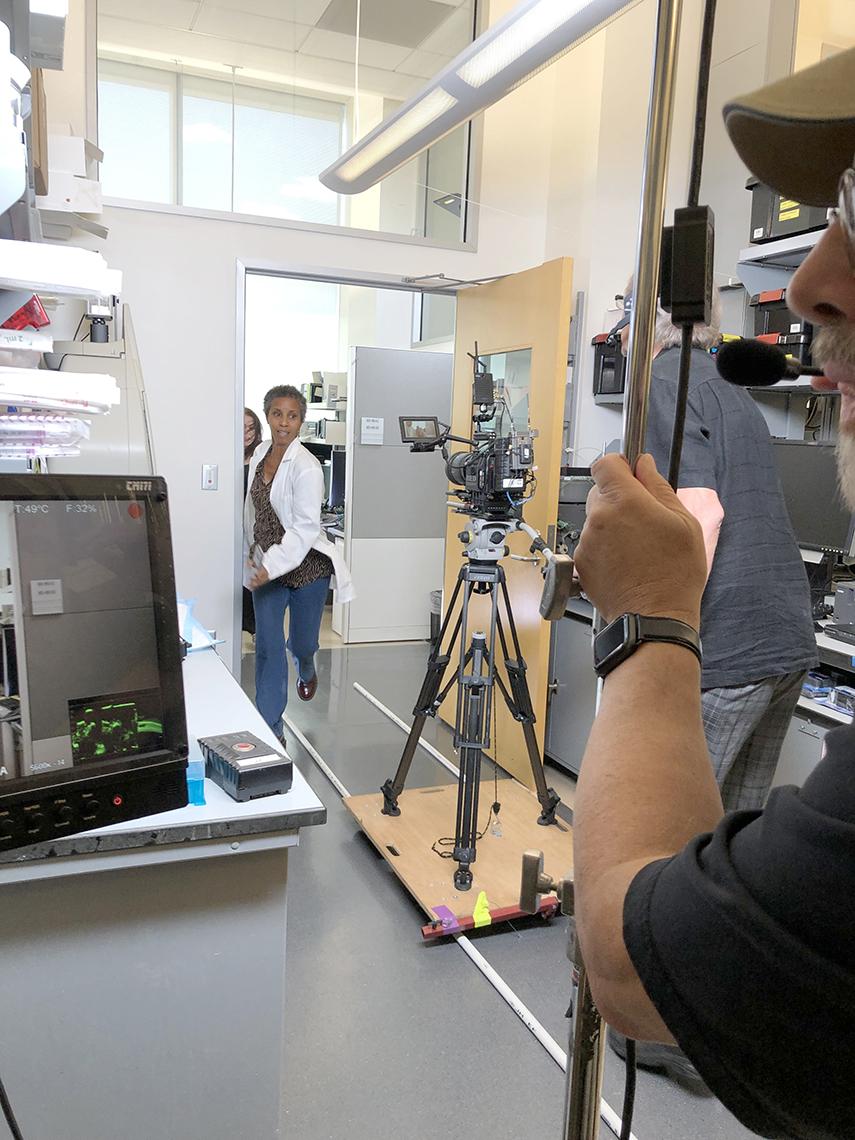 Female actor in lab coat running towards camera