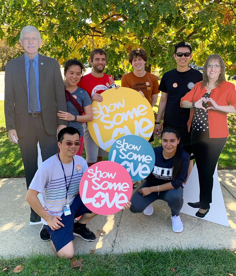 CFC enthusiasts pose with cardboard cutouts of CFC leaders.