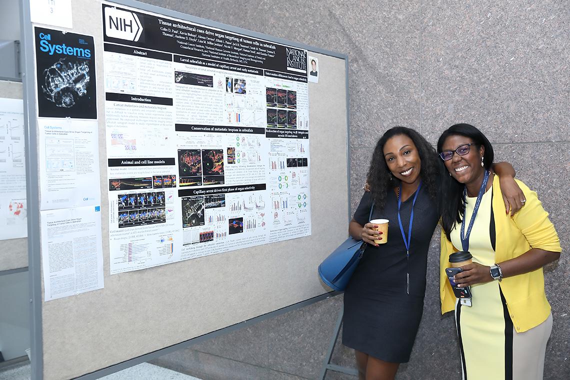 Drs. Tanner and Joseph chat before the poster session starts.