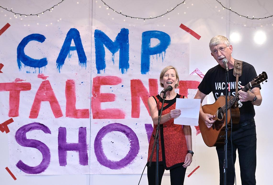 Dr. Collins plays guitar and sings with his wife at talent show.