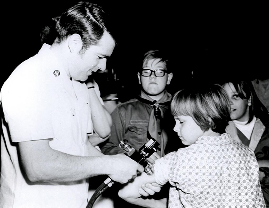 Doctor gives a vaccine shot to a child