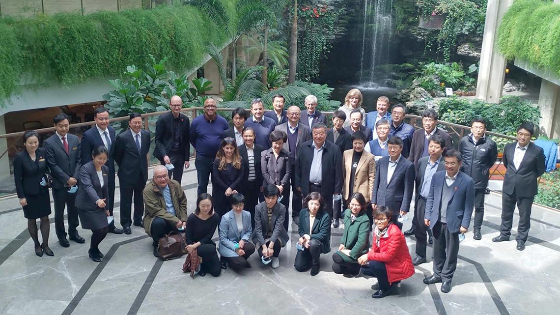 Group of more than 2 dozen people facing camera