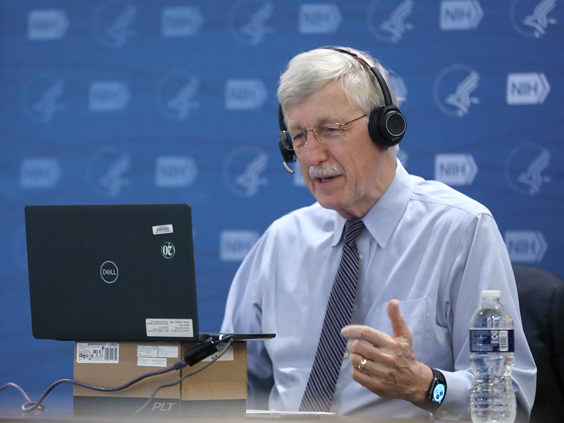 Collins wearing headset sits in front of computer screen