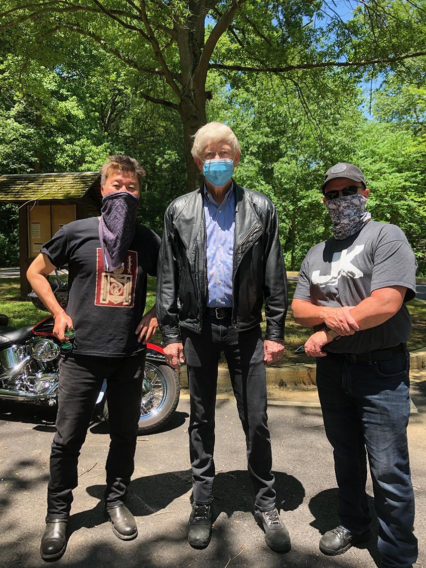 Three NIH'ers get ready to ride motorcycles.