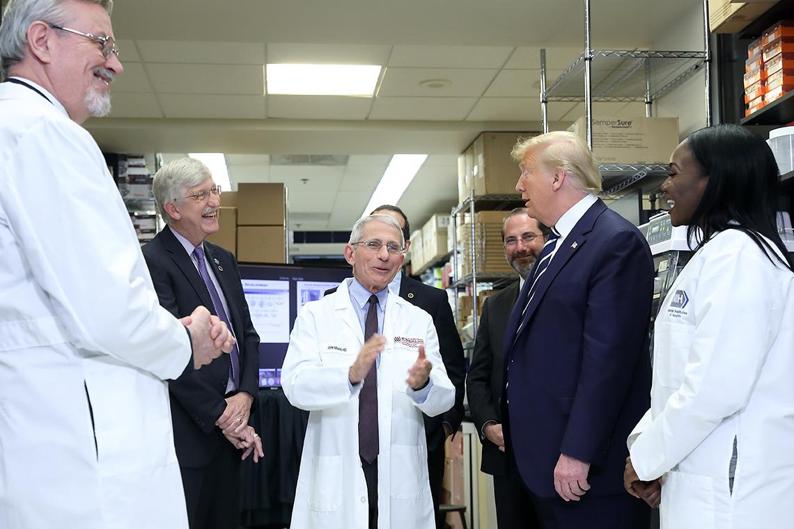 Graham, Collins, Fauci, Azar, Trump, and Corbett in a lab