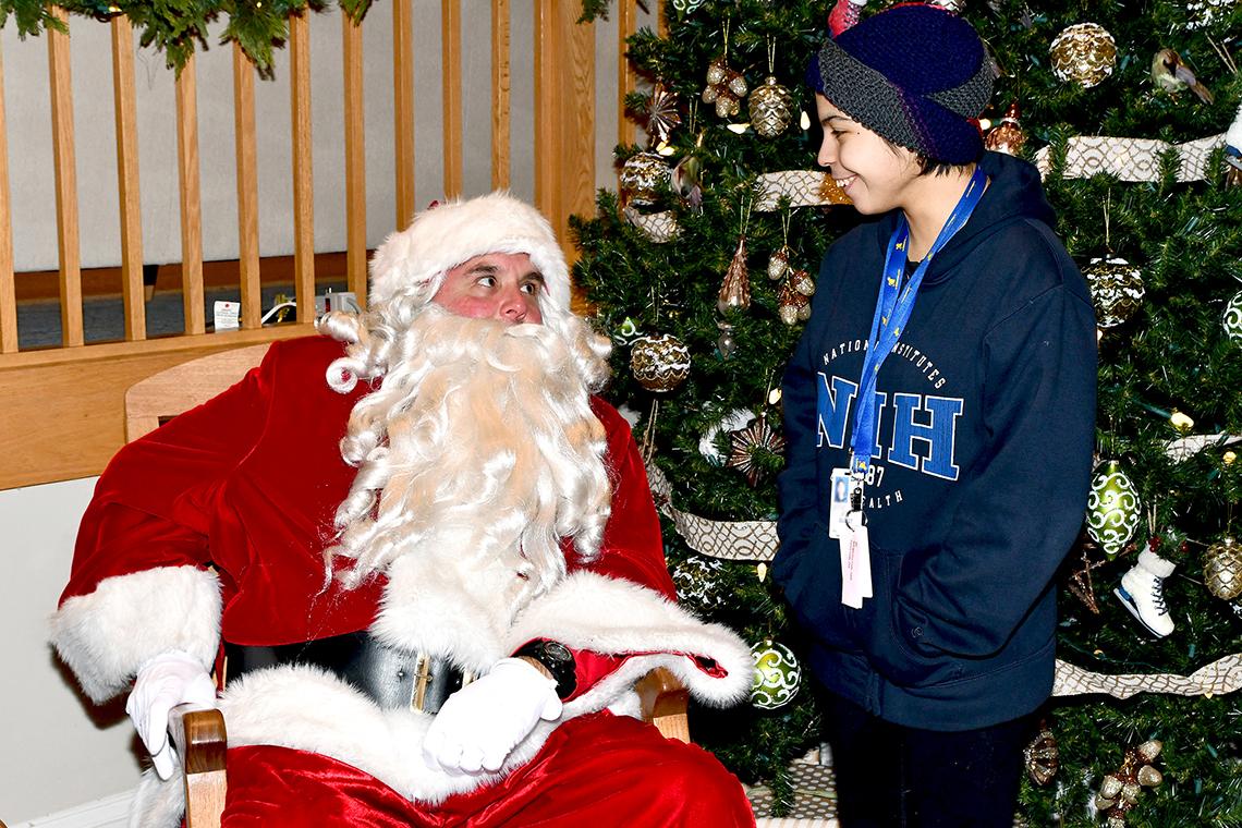 Santa talks with a teenager.