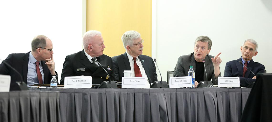 Five men sit on panel