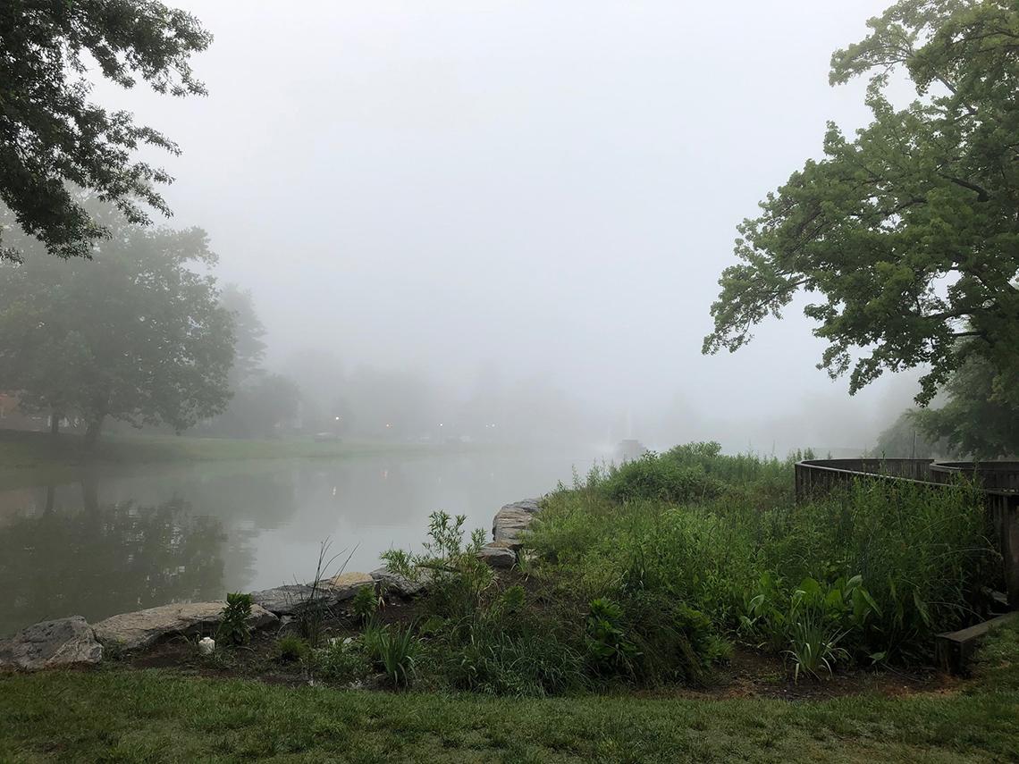 Fog hovers over the lake at Baker Park in Frederick, Maryland.