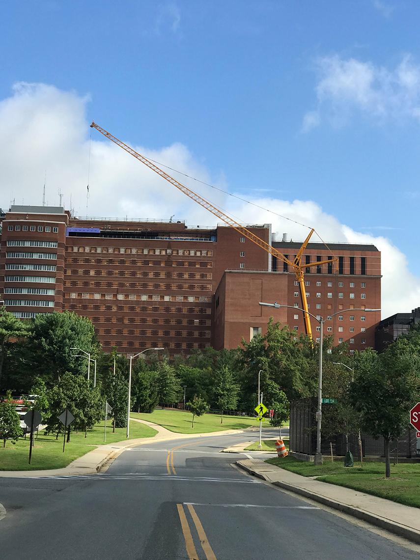 Crane lifts steel to roof.