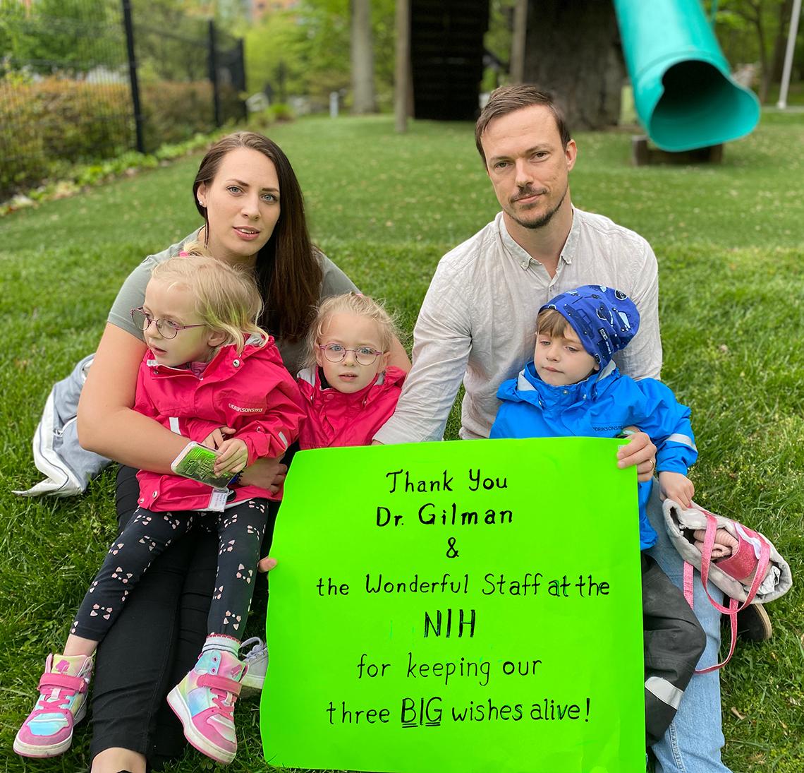 The Flysjo family poses together on the lawn on the NIH campus.