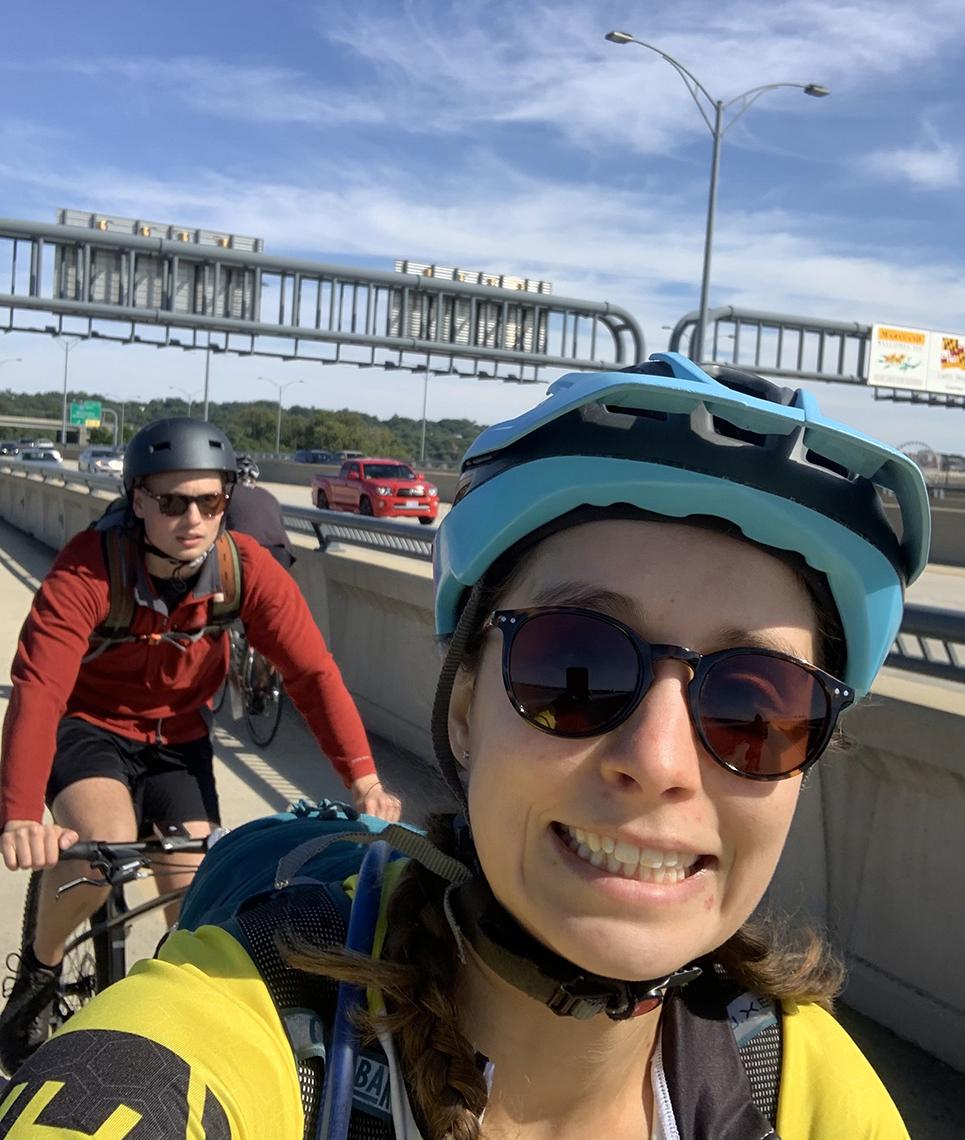 A smiling Langner leads the way on her bike with colleague and friend Joe Krzeski riding behind her.