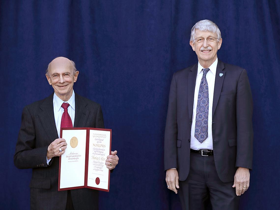 Dr. Alter holds diploma, with Dr. Collins