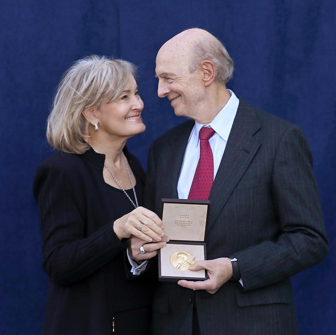 Alter and his wife look at medal.