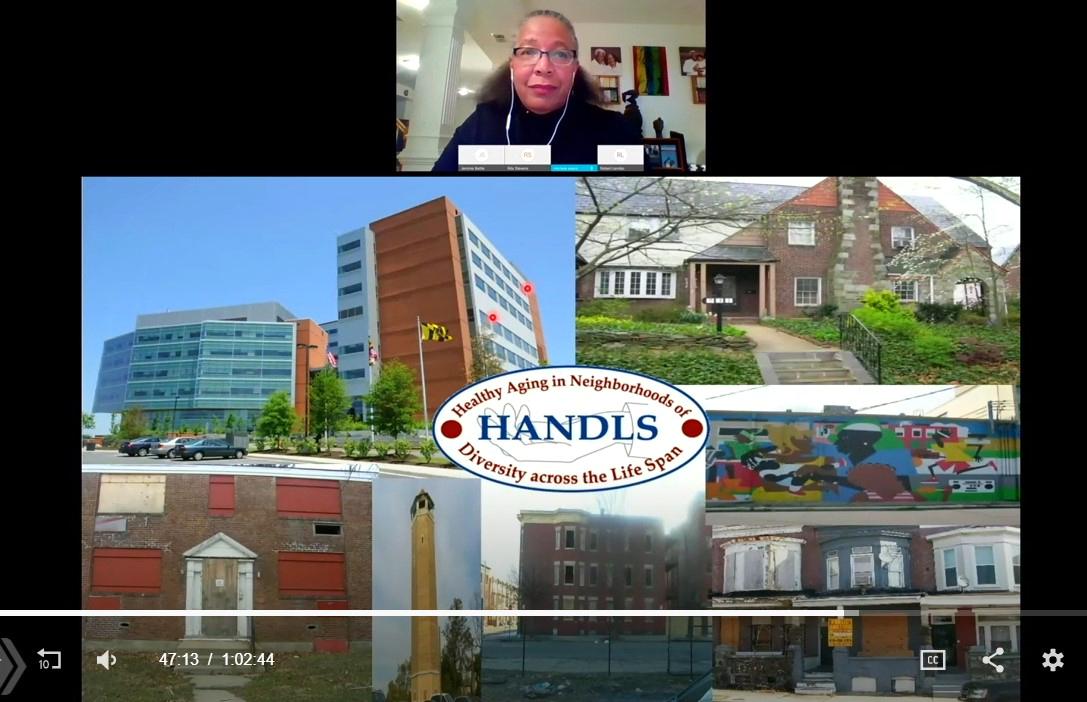 Evans speaks during the videocast, with images across Baltimore displayed on the screen.