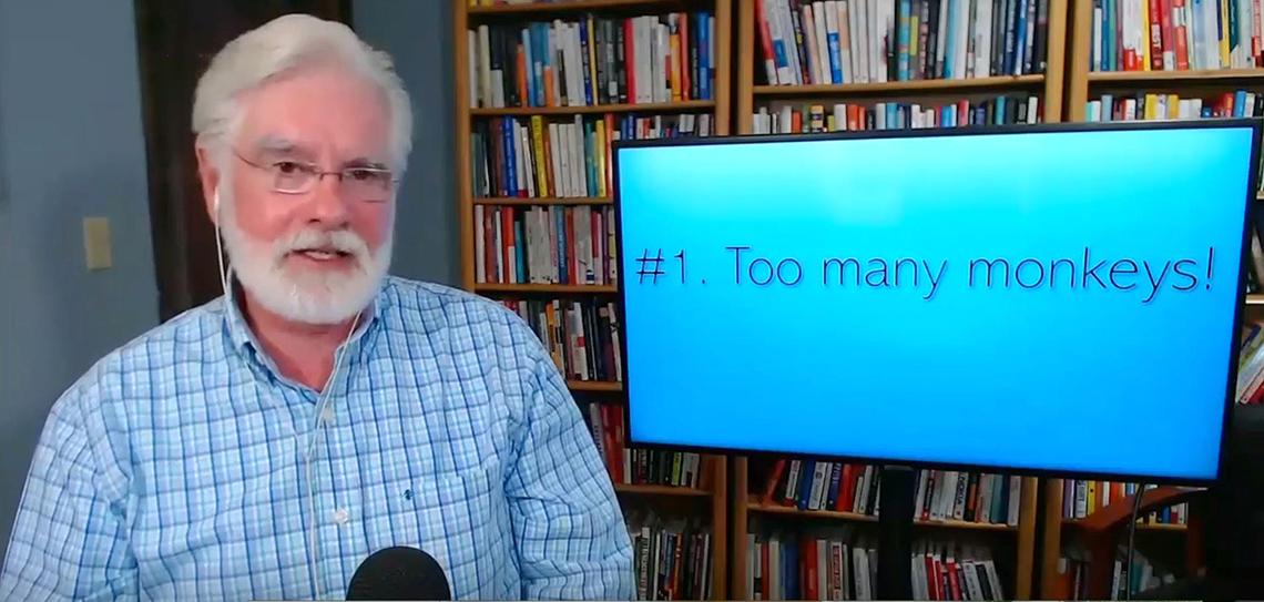 Rockwell speaks virtually in front of a screen that reads "Too many monkeys!"