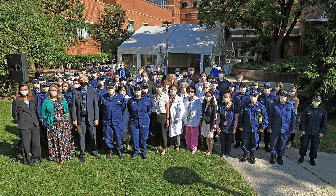 Members of the vaccine clinic stand for a group photo outside of the CC