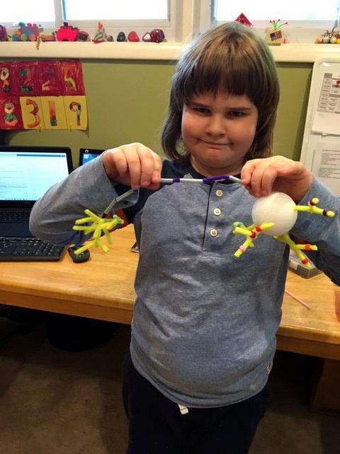 Brown holds up a model of a neuron