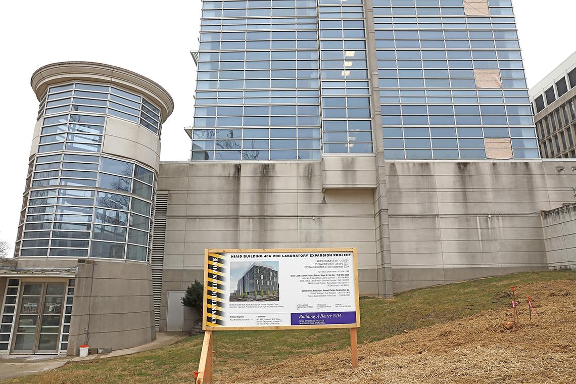 Construction sign on lawn of building