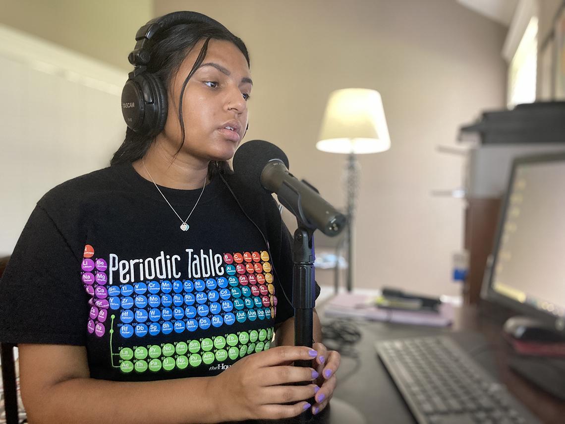 Nadella speaks into a microphone